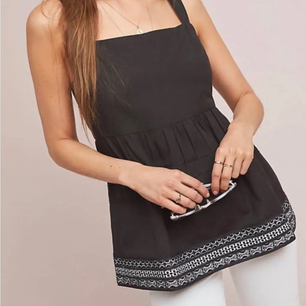 Black tank top with white detailing at bottom.  Size small.